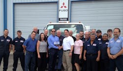 Todd Bloom (center left), MFTA's President & CEO, presents the Mitsubishi Fuso North American Dealer of the Year Award to Frank Messina, dealer principal, as he is joined by other employees of Messina Truck Center, Tampa, Fla. Todd Bloom (center left), MFTA's President & CEO, presents the Mitsubishi Fuso North American Dealer of the Year Award to Frank Messina, dealer principal, as he is joined by other employees of Messina Truck Center, Tampa, Fla.