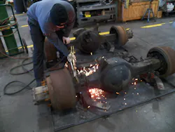 Cutting off the old U-bolts using a blowtorch. The technician during the work is Wes Doub of WheelTime Network/Clarke Power Services.