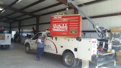 Carl Adams reads a copy of PTEN magazine near his T3 toolbox truck outfitted with a crane, the longest truck in the company's fleet. Carl Adams reads a copy of PTEN magazine near his T3 toolbox truck outfitted with a crane, the longest truck in the company's fleet.