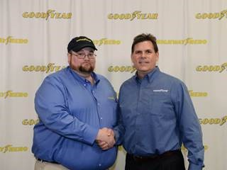 Julian Kaczor, winner of the 33rd Goodyear Highway Hero Award shakes hands with Gary Medalis, Goodyear marketing director.