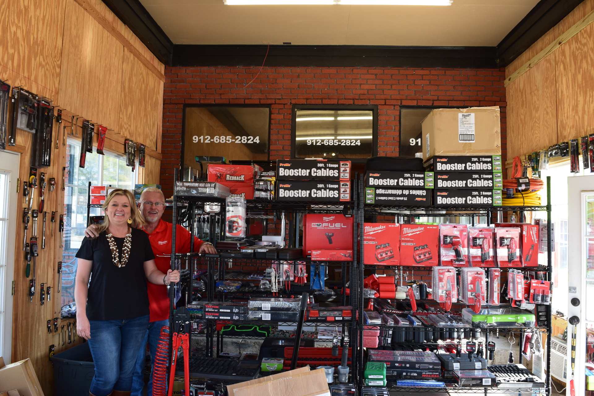 Colley stands beside his wife, Lisa, inside their storefront location in Metter, Ga.
