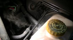 Using a Redline Detection high-pressure smoke machine, this image shows a previously undetected leak coming from a brake booster check valve.