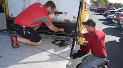 Mac Tools distributor Doug Mansell (left) gets assistance from one of his customers to diagnosis an issue with the truck liftgate.