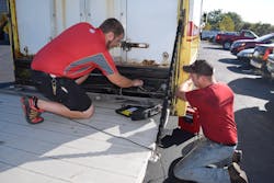 Mac Tools distributor Doug Mansell (left) gets assistance from one of his customers to diagnosis an issue with the truck liftgate. Mac Tools distributor Doug Mansell (left) gets assistance from one of his customers to diagnosis an issue with the truck liftgate.