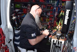 Jenkins Jr. writes up a sales ticket for a customer at a shop. To the right, his vise is situated to service and repair customer tools. Jenkins Jr. writes up a sales ticket for a customer at a shop. To the right, his vise is situated to service and repair customer tools.