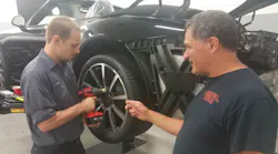Cornwell Tools dealer Bob Shaftel (right) talks with a customer who is testing out a cordless tool in the shop.
