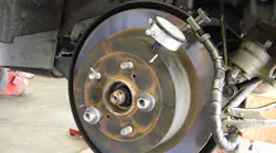 This image illustrates using a dial indicator to check for hub or rotor run out.