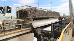 Each trailer is driven onto the wet hopper and tilted to the side to dump the sugar beets. Each trailer is driven onto the wet hopper and tilted to the side to dump the sugar beets.