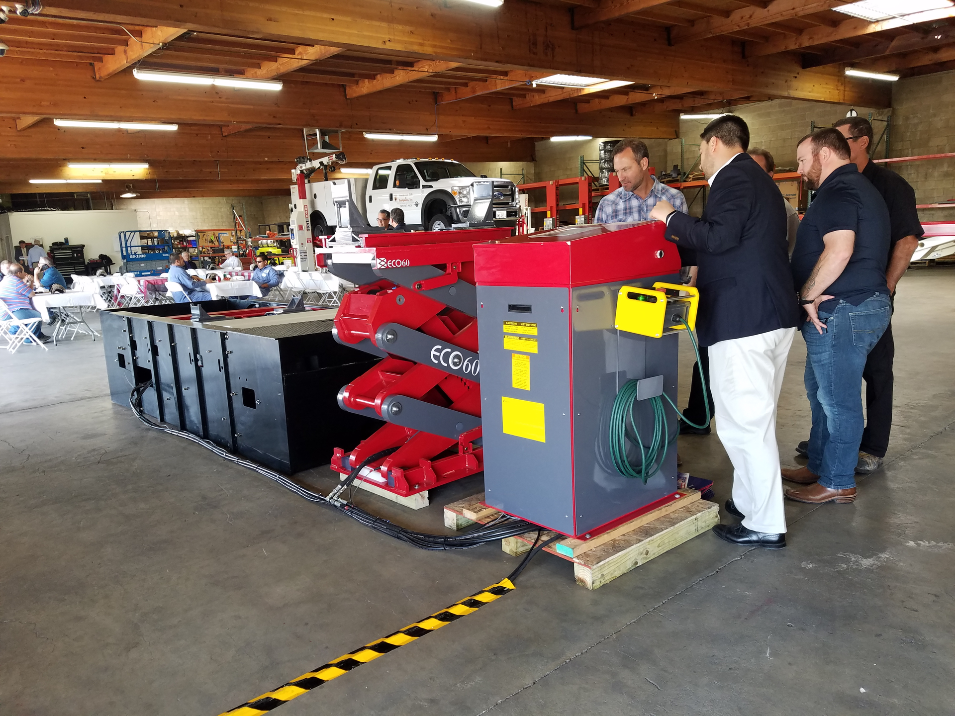 Heavy duty inground lift sales manager, Matthias Lennemann (in blue blazer), shows attendees the workings of a Stertil-Koni Ecolift at a recent education and safety forum hosted by Southwest Lift & Equipment in San Bernardino, Calif.
