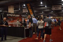 Attendees visit the Streamlight booth during the Medco 2018 Customer Show.