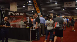 Attendees visit the Streamlight booth during the Medco 2018 Customer Show.