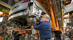 Greg Middleton, a GM employee for 28 years, marries the chassis to the body of a 2015 Buick Enclave in 2015 at the General Motors Lansing Delta Township Assembly plant. (The assembly plant pictured here will remain in production in 2019.)