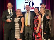 LSI President and Founder Chris Gabrelcik accepts the Smart 50 Award for Innovation, sponsored by Smart Business Magazine, with members of his family.
