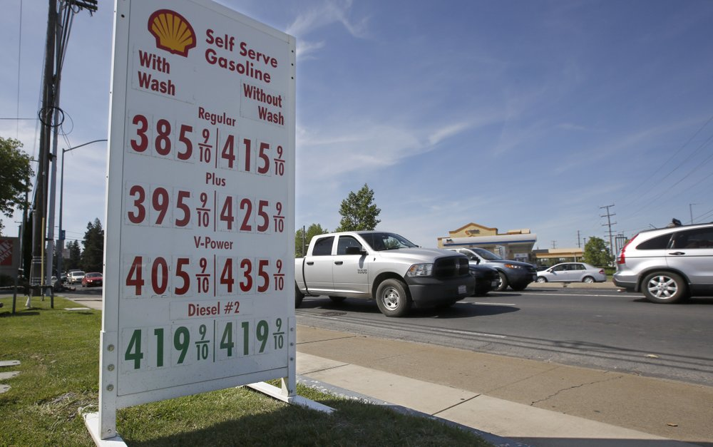 This April 23 file photo shows gas prices displayed at a Shell station in Sacramento, California. Four major automakers have reached a secret deal with California to increase gas mileage and greenhouse gas emissions standards, bypassing the Trump administration&rsquo;s plan to freeze standards at 2021 levels, according to two people briefed on the matter.