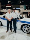 Grand Prize winner Jim Pickles and &apos;The King&apos; Richard Petty aside Pickles&apos; supercharged Dodge Challenger at MAHLE&apos;s booth at AAPEX.