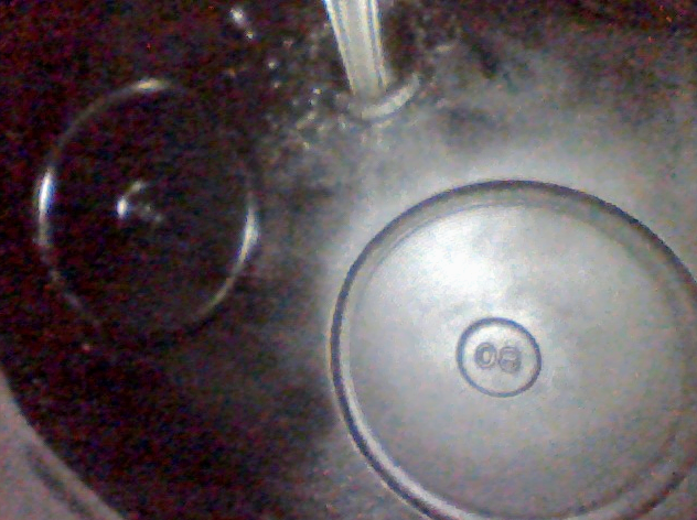 In this image, a technician is looking up at the valves in a diesel engine using a Vividia D3145 articulating camera.