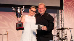 Rebecca Chewning receiving her trophy for All-Around Grand Champion of the Hino parts division from 'Rusty' Rush.