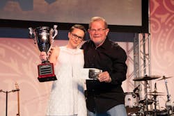 Rebecca Chewning receiving her trophy for All-Around Grand Champion of the Hino parts division from &apos;Rusty&apos; Rush.