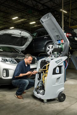 A technician works with MAHLE's ACX2250 service unit. A technician works with MAHLE's ACX2250 service unit.