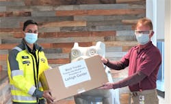 LVO employee Richi Ramlal (left) presents face shields to Lehigh Center representative Glenn Trunk (right).
