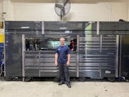 John Harris stands in front of his 17’ wide by 8’ tall Snap-on toolbox