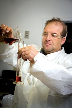 Kevin Adams, vice president of research and development, LSI Chemical, tests a new LSI Chemical oil additive. Kevin Adams, vice president of research and development, LSI Chemical, tests a new LSI Chemical oil additive.