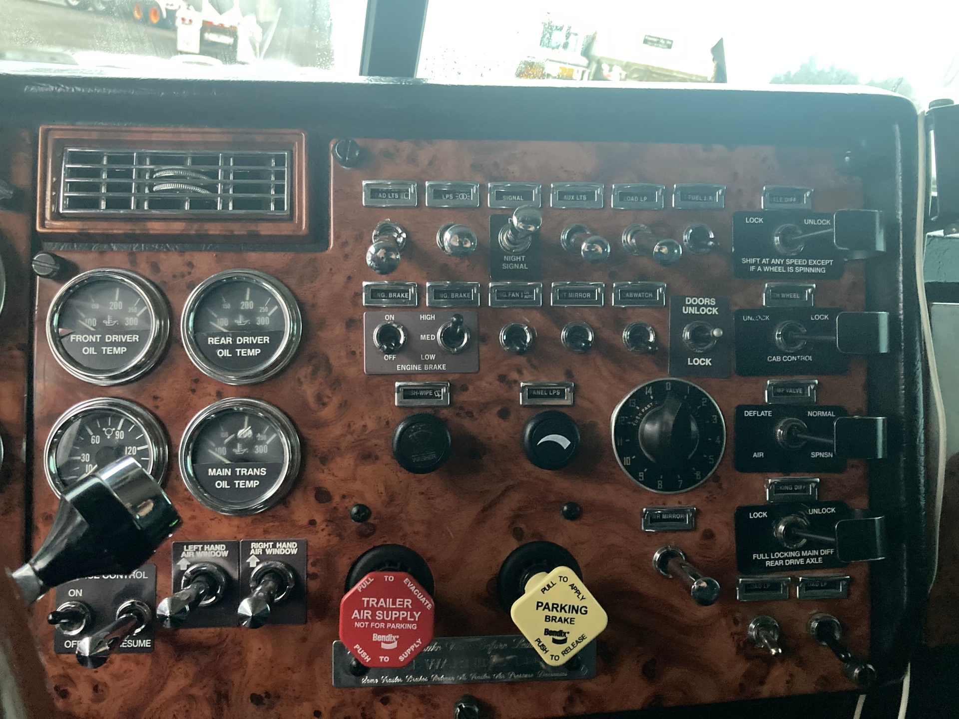 Image of a Peterbilt 378 dash. Imagine all of the wiring required to operate the many switches and gauges on this vehicle.