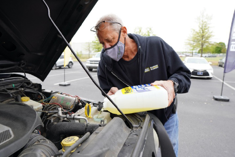 An Alliance Parts Warehouse, Inc. employee refills wiper fluid as part of APW&rsquo;s &ldquo;Be Car Care Aware&rdquo; event April 16, 2021.