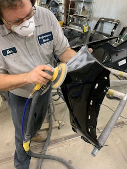 Figure 3 - Technician wears a respirator when sanding. Figure 3 - Technician wears a respirator when sanding.