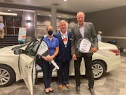 Randi Ruthart-Garrison is presented a 2014 Ford Fusion, refurbished by Town East Ford, by NABC Immediate Past Chair Darren Huggins (c.) and Don Porter, CEO of URG.