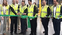 Members of the MANN+HUMMEL team, with representatives from DHL present, cut a green ribbon to signify the opening of the new West Coast Distribution Center. MANN+HUMMEL team members in yellow safety jackets include (left to right): Isabell Kloess, Stefan Tolle, Kurk Wilks, Rodrigo Reyes, Karl Westrick and Sergio Bellacicco.