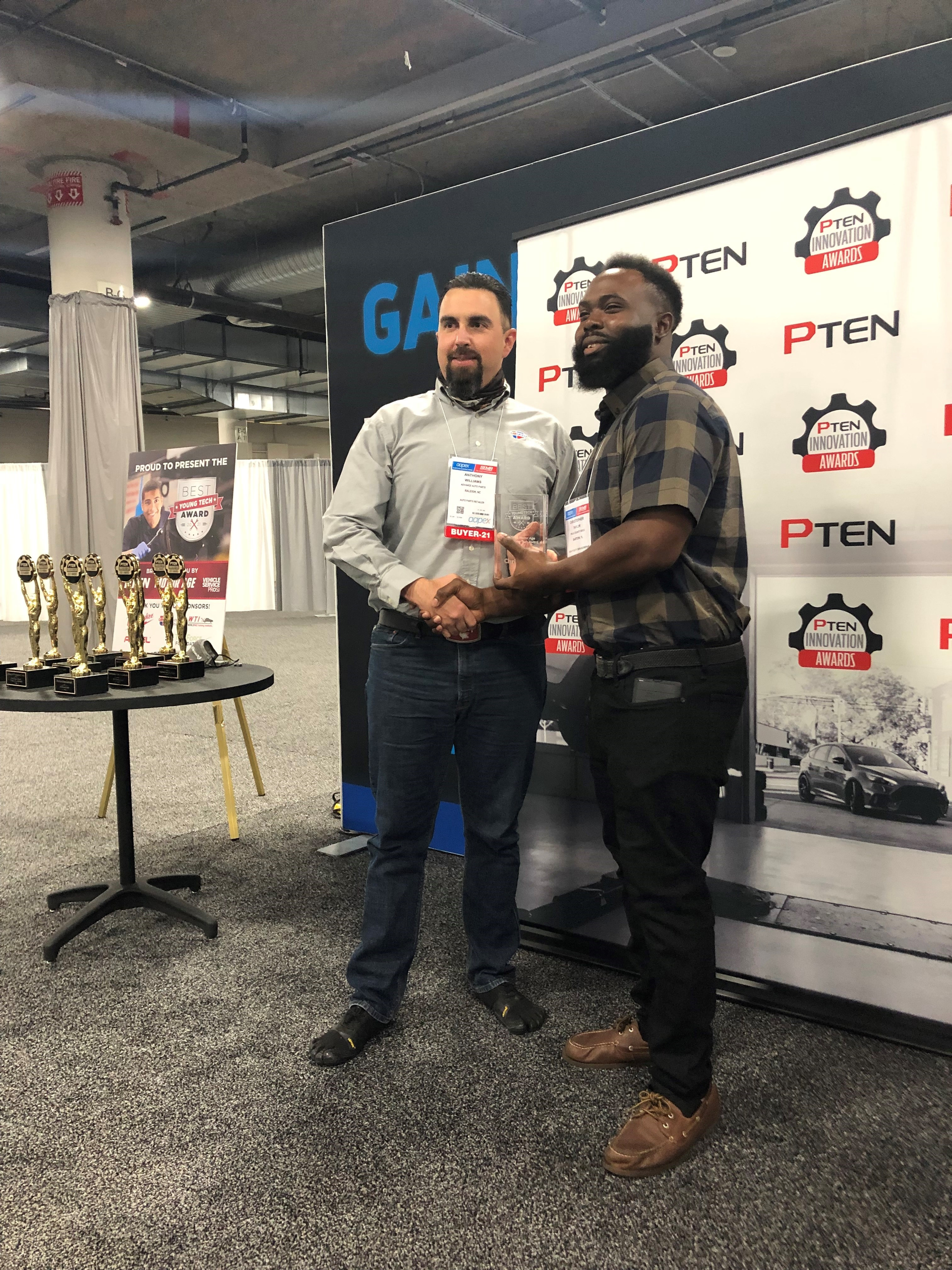 Anthony Williams (left) of Advance Auto Parts presents the Best Young Tech Award to Chris Taylor (right), fleet technician at Polk County.