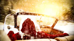 Santa driving a car into the sun