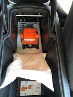 FIG 7: This Chevrolet Volt’s (PHEV) HV service plug for the “big battery” is hidden in the center console. If you remove it while the 12-volt Aux “little battery” is still connected OR a Level 1 / 2 charging cable is connected to the vehicle, a DTC may set and put a default state into motion resulting in an I.C.E. only vehicle until the DTC is cleared. The GM factory scan tool software can do the job and 1,000 other tasks such as place the BECM into relearn mode to allow a replacement “big battery” into the vehicle. Comparable to registering a new “little battery” on a late model Ford F150 or Mini Cooper, failing to do this can result in performance and or longevity issues to the “big battery”. FIG 7: This Chevrolet Volt’s (PHEV) HV service plug for the “big battery” is hidden in the center console. If you remove it while the 12-volt Aux “little battery” is still connected OR a Level 1 / 2 charging cable is connected to the vehicle, a DTC may set and put a default state into motion resulting in an I.C.E. only vehicle until the DTC is cleared. The GM factory scan tool software can do the job and 1,000 other tasks such as place the BECM into relearn mode to allow a replacement “big battery” into the vehicle. Comparable to registering a new “little battery” on a late model Ford F150 or Mini Cooper, failing to do this can result in performance and or longevity issues to the “big battery”.