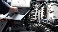 Auto repair technician diagnosing vehicle