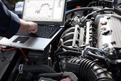 Auto repair technician diagnosing vehicle Auto repair technician diagnosing vehicle