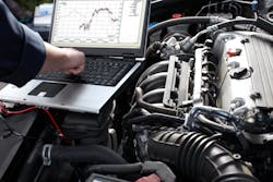 Auto repair technician diagnosing vehicle