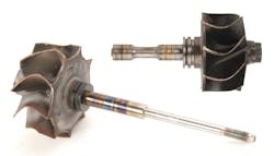 Figure 2- This photo illustrates bearing material transfer due to lack of lubrication on the turbine shaft (at top). The turbine impeller shows wheel rub where it contacted the turbine housing. The turbine shaft/wheel (bottom) shows excessive heat damage on the bearing journals due to a lack of lubrication. Figure 2- This photo illustrates bearing material transfer due to lack of lubrication on the turbine shaft (at top). The turbine impeller shows wheel rub where it contacted the turbine housing. The turbine shaft/wheel (bottom) shows excessive heat damage on the bearing journals due to a lack of lubrication.