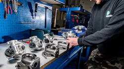 A Melett Limited technician is hard at work manufacturing turbochargers.