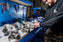 A Melett Limited technician is hard at work manufacturing turbochargers.