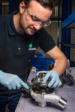 Figure 4- Because a turbocharger is a precision piece of equipment it requires skill and experience to service. This technician is mounting a CHRA to the compressor housing. On a small turbo like the one shown compressor/turbine wheel speeds can reach over 250,000 rpm.