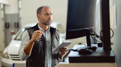 Technician checking reports Technician checking reports