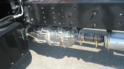 Full exhaust aftertreatment system mounted to the bottom of the chassis rail on an Isuzu 7500.