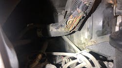 Figure 9- A careful visual inspection was conducted, and a suspect are in the engine bay's wiring harness was cause for further scrutiny. The AC compressor clutch control circuit was damaged. Figure 9- A careful visual inspection was conducted, and a suspect are in the engine bay's wiring harness was cause for further scrutiny. The AC compressor clutch control circuit was damaged.