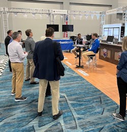Seated at the table, Sunil Patel (left), with Tekmetric, and Parker Swift (right), with Mechanic Advisor, discuss business solutions at the Supplier and Training Expo (STX) with Bob Cushing, executive vice president of Advance Professional and president of Worldpac, with media and marketing representatives in attendance. Seated at the table, Sunil Patel (left), with Tekmetric, and Parker Swift (right), with Mechanic Advisor, discuss business solutions at the Supplier and Training Expo (STX) with Bob Cushing, executive vice president of Advance Professional and president of Worldpac, with media and marketing representatives in attendance.