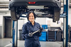 Female mechanic smiling with wrench Female mechanic smiling with wrench
