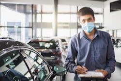 Inspector in auto shop with clipboard Inspector in auto shop with clipboard