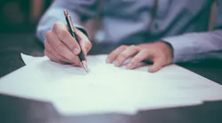 A man signs a contract