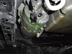 Figure 1- Leaking refrigerant dye that the customer mistook for antifreeze and the technician missed during his cooling system diagnosis. Figure 1- Leaking refrigerant dye that the customer mistook for antifreeze and the technician missed during his cooling system diagnosis.