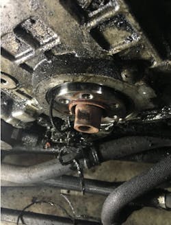 Figure 13 - Old drive belt material being pulled from behind the damaged crankshaft seal. Figure 13 - Old drive belt material being pulled from behind the damaged crankshaft seal.